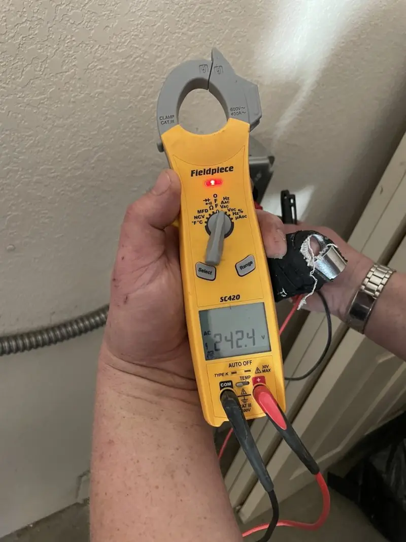 Voltage testing with clamp meter during Ceiling Fan Installation in Elsmere